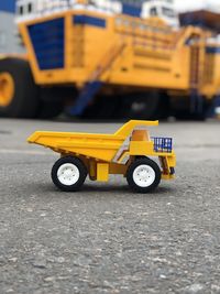 Close-up of yellow toy car on road