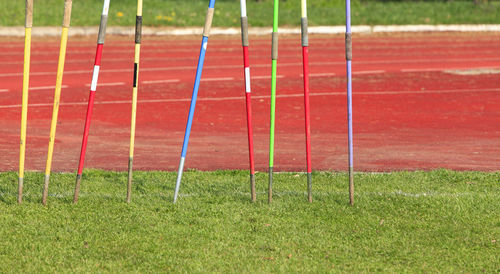 Colorful javelin sticks on field