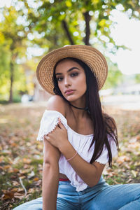 Portrait of a beautiful young woman sitting outdoors