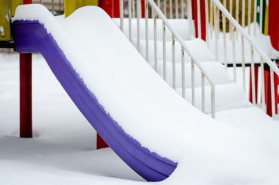 Close-up of snow covered staircase in building