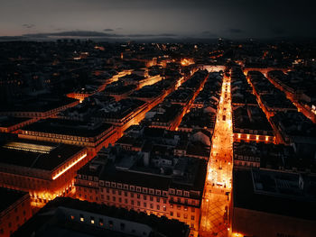 High angle view of illuminated buildings in city at night