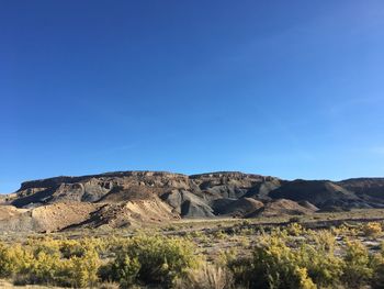 Scenic view of rocky mountains against clear blue sky