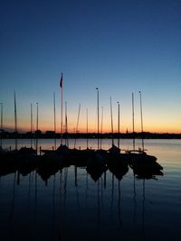 Boats in sea at sunset