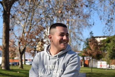 Portrait of smiling young man against plants