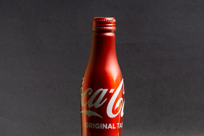 Close-up of glass bottle against black background