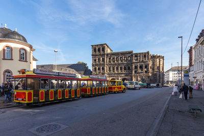 View of city street and buildings against sky