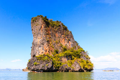 Rock formations in sea against sky