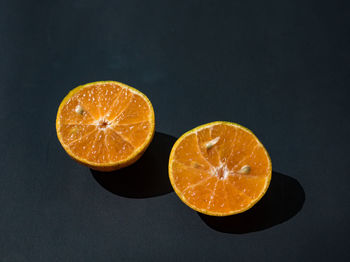 Close-up of orange slices on black background