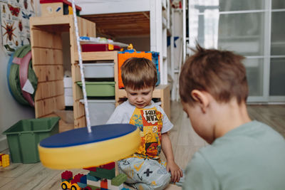 Portrait of cute baby boy sitting on table