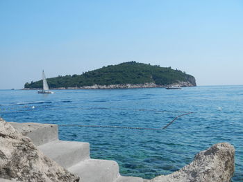 Scenic view of sea against clear blue sky