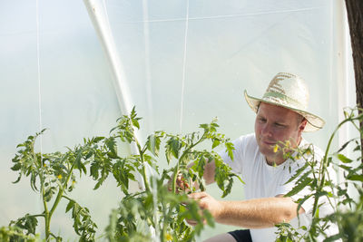 Man standing by flowering plants