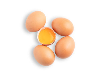 Close-up of eggs against white background