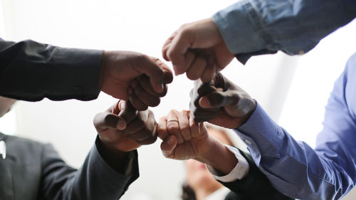 Midsection of man holding hands