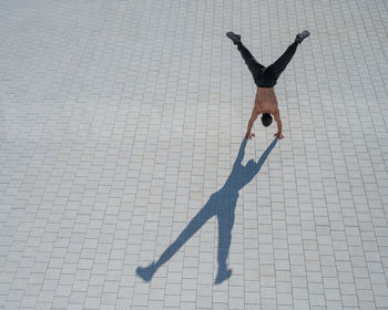 Low angle view of woman standing on snow