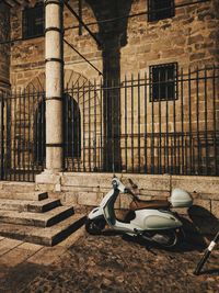 Rear view of woman sitting on street