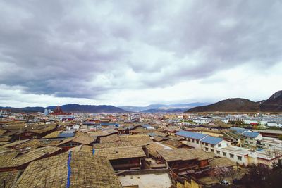 High angle view of houses in town against sky