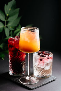 Glass of alcoholic coctail with ice on black background