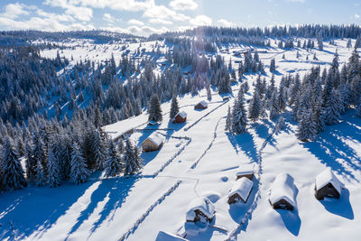 Snow covered remote village, homestead in the mountains. aerial drone view