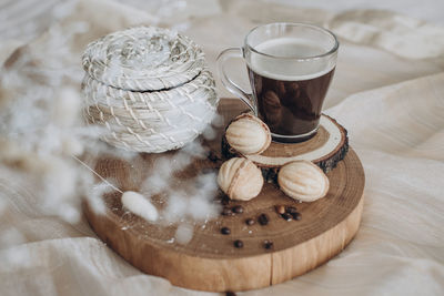 Still life cup coffee with cookies nuts on a wooden stand top view