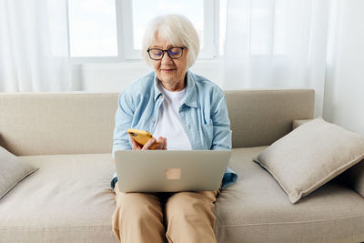 Young woman using laptop at home