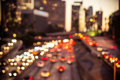 Defocused image of illuminated city street at night