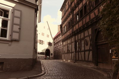 Street amidst buildings in city against sky