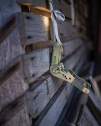 Close-up of metal hanging on wood