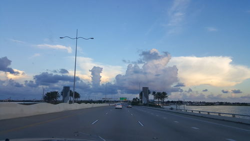 Cars on road against sky