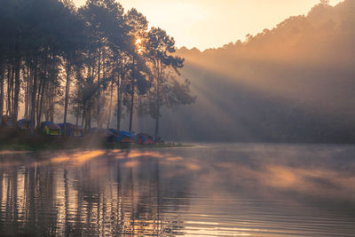Morning sunrise over stream and pine tree camping in lake at pang ung lake, mae hong son , thailand