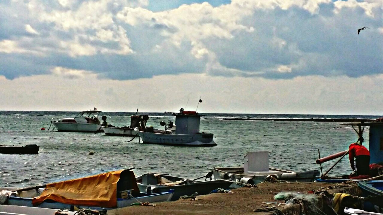 sea, sky, water, nautical vessel, transportation, horizon over water, mode of transport, bird, cloud - sky, boat, flying, scenics, beach, tranquility, nature, beauty in nature, tranquil scene, cloud, moored, animal themes