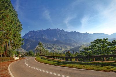 Road amidst mountains against sky