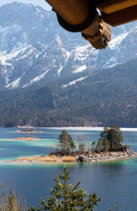 Scenic view of lake by snowcapped mountains