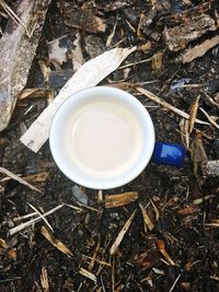 High angle view of coffee cup on field