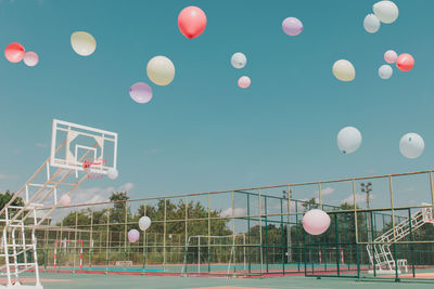 Low angle view of balloons against sky