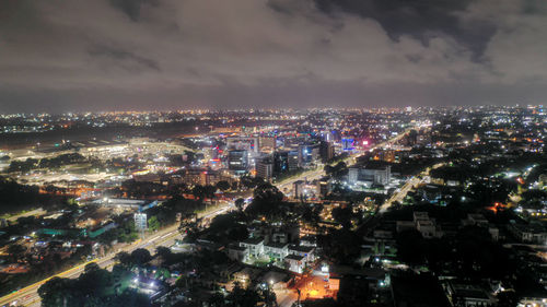 High angle view of illuminated city buildings against sky