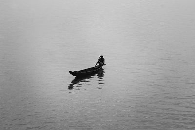 Man sitting on boat in sea