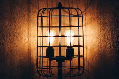 Close-up of light bulb against wall