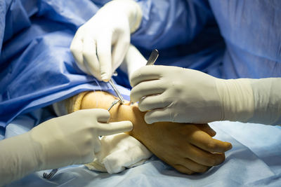 Midsection of doctor examining patient