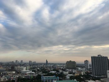 City buildings against cloudy sky