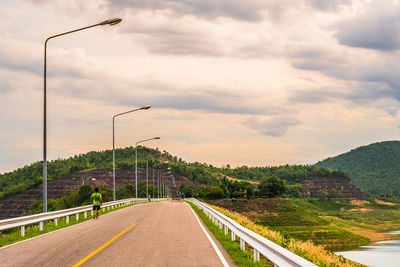 Street by road against sky