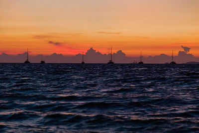 Scenic view of sea against orange sky