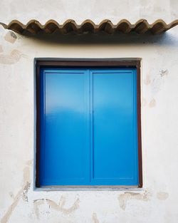 Close-up of closed blue window of house