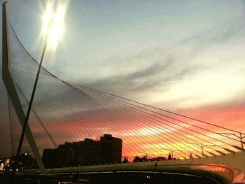 Low angle view of suspension bridge against sky during sunset