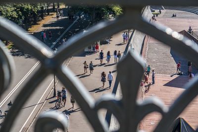 Tourists on street viewed through window