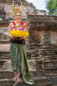 Portrait of woman in traditional clothing standing outdoors