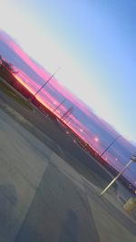 Low angle view of illuminated lights against sky during sunset