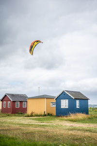 Low angle view of person paragliding against sky