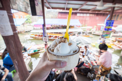 Cropped hand of man holding ice cream