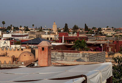 Town by buildings in city against clear sky