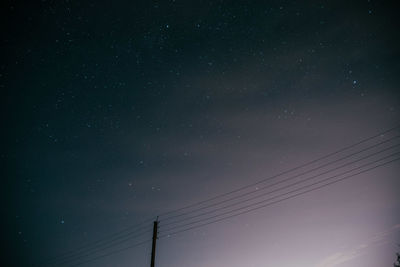 Low angle view of cables against sky at night